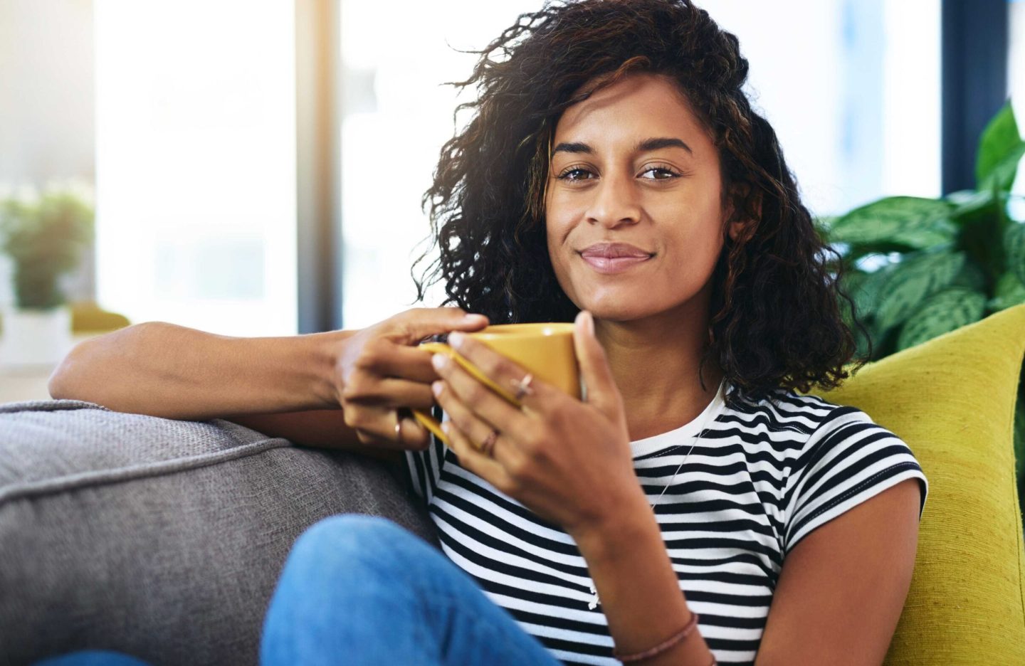Woman, portrait and coffee on sofa for relax, comfort and study break on weekend in home. Girl, student or tea in Brazil apartment for rest, stress relief or peace of mind for wellness in living room.
